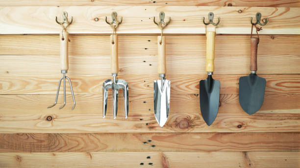 istock gardening tools hanging on a wooden wall 2162278435