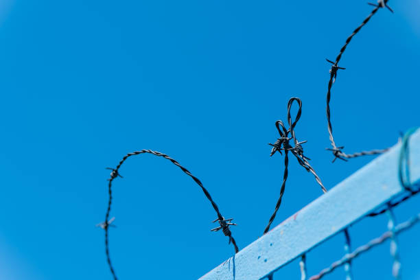 a fence with barbed wire on top of it