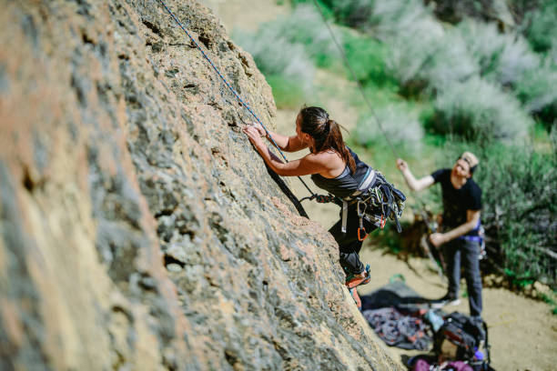 istock Woman uses rope to climb Smith Rock 2162291889