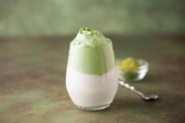 istock Dalgona Matcha Latte, a creamy whipped matcha in glasses, on green background. 2162292094