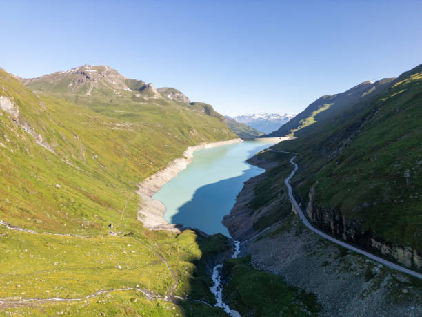 istock Serene Mountain Lake with Winding Road 2162295612