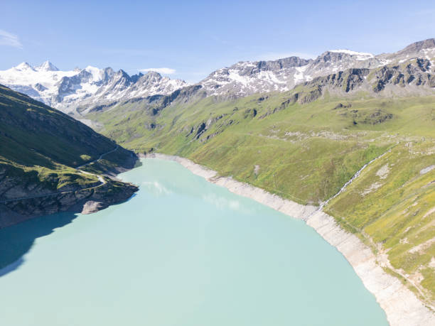 istock Turquoise Alpine Lake with Snow-Capped Mountains 2162295704