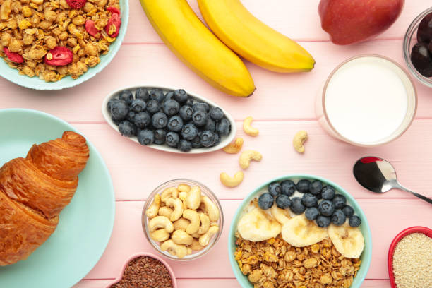 istock Healthy breakfast set on pink background. Granola with fresh summer berries 2162298812