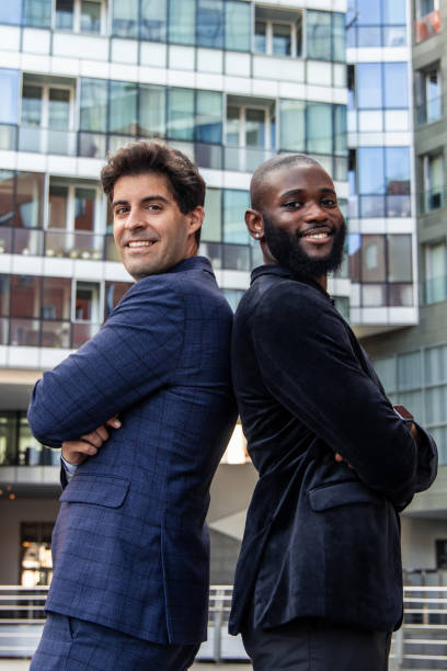 istock vertical Multicultural businessmen posing confidently back-to-back in urban business district 2162300481
