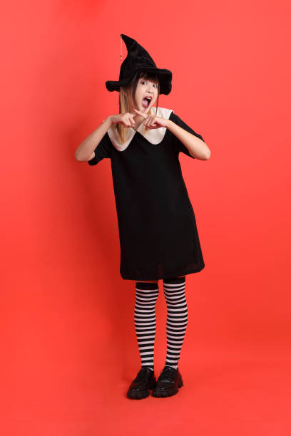 Studio shot of a cute little girl wearing a funky hat against a white background