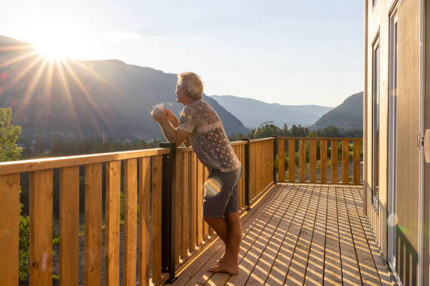 istock Senior man looks at mountains from verandah 2162303742