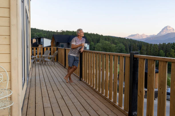 istock Senior man looks at mountains from verandah 2162303775