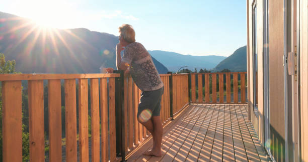 istock Senior man looks at mountains from verandah 2162303813