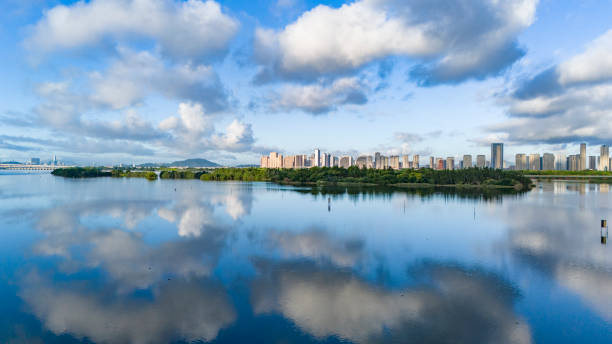 Green city and blue sky with white clouds