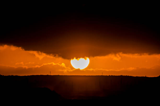 istock The sun is setting over a hill with a cloudy sky 2162307386
