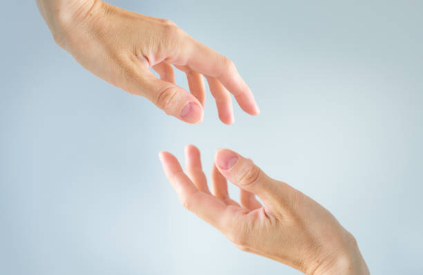 istock Helping concept hands reaching out to help each other isolated on light blue background. 2162308137