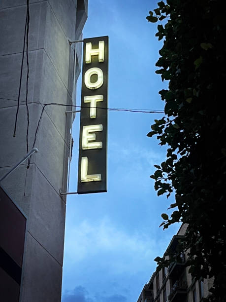 Illuminated hotel sign at dusk