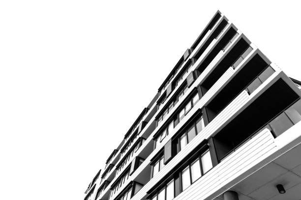 istock Black and white closeup low angle view of modern apartment building, background with copy space 2162309355