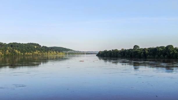 istock Serene river landscape with a bridge in the distance under a clear blue sky 2162310510
