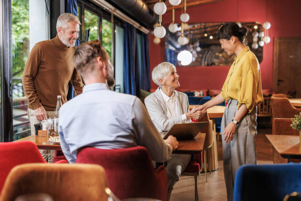 istock Business colleagues meeting in a modern restaurant setting 2162311655