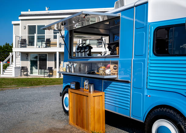 The Little Blue Food Truck is a new addition to the pier at the mouth of Falmouth Harbor in Falmouth, MA on Cape Cod, MA.  The truck is designed to look like a small French delivery truck, but is actually a trailer positioned on the pier.  The bright blue truck serves an assortment of coffees and fresh baked pastries.