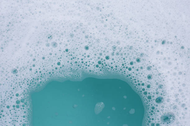 istock Detergent foam bubble on water. Blue background, Soap sud 2162314270