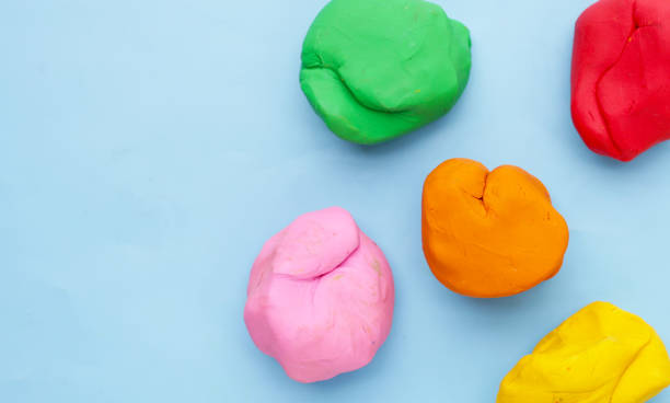istock Colorful plasticine clay on blue background. 2162314330