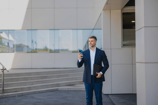 istock Business professional using mobile phone outdoors 2162315180