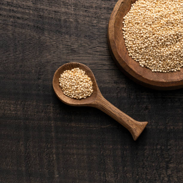 istock Chenopodium quinoa - White organic quinoa seeds in the bowl and spoon - Rustic background 2162315267