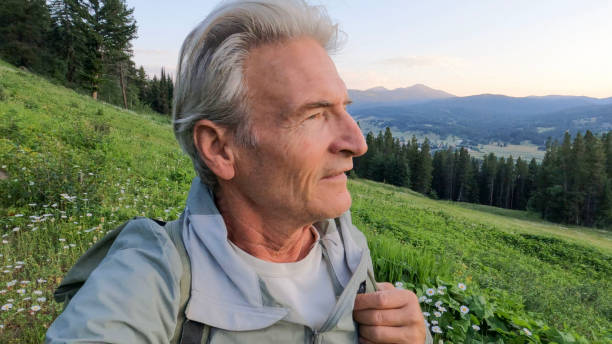 istock Mature man hikes through mountain meadow 2162317876