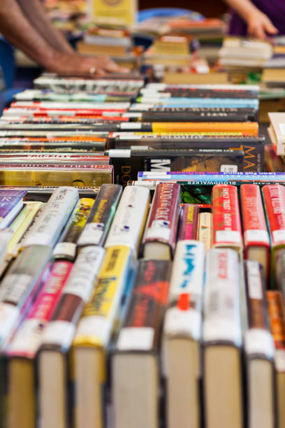 istock People Looking Through Stacks of Used Books 2162318004
