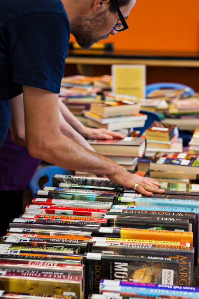 istock Person Looking Through Stacks of Used Books 2162318046