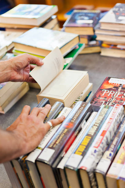 istock Person Looking Through Stacks of Used Books 2162318064