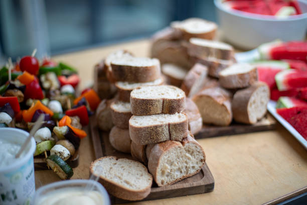 istock Freshly sliced bread on a wooden board 2162319407