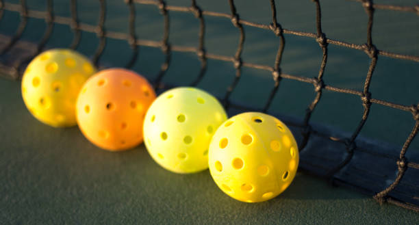 istock Four Pickleballs Early Morning Net Close-Up 2162320598