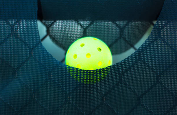 istock Single Yellow Pickleball Hangs in Net Pocket 2162320613