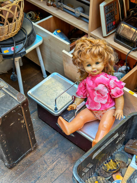 Female doll amongst other discarded items at indoor market in Tallinn, Estonia