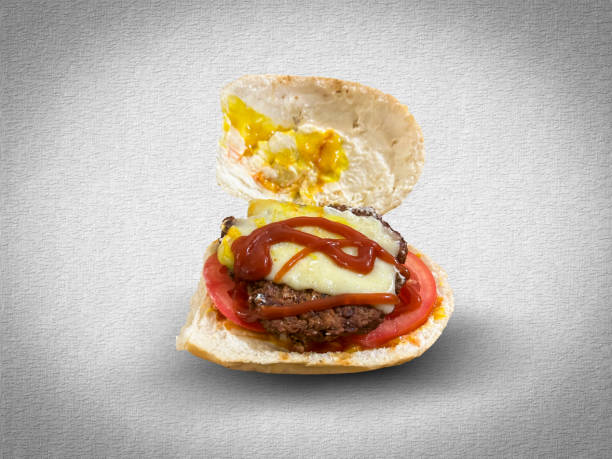 istock Delicious burger with cheese and sauces being prepared on white background 2162326458