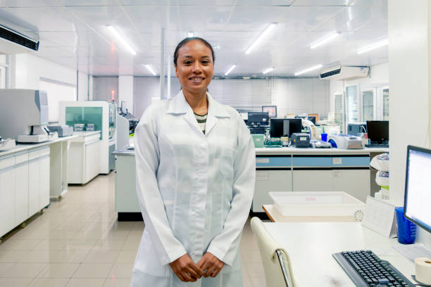 Photo of a woman using lab coat working in a lab.