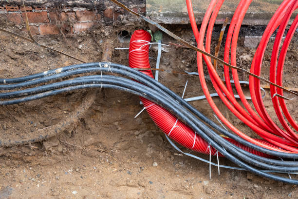 istock electric and high-speed Internet Network cables in red corrugated pipe are buried underground 2162327632