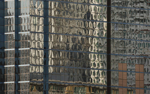 istock Architectural exterior of modern building facade with blue sky and clouds reflection in windows. 2162329527