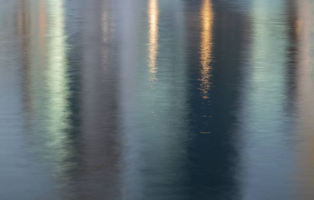 Abstract photo art Reflection in water surface. Ripples on the water of a lake with light reflections, Water wave background, Copy space, Selective focus.