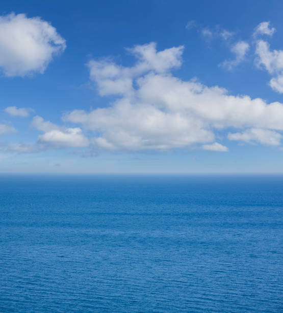 istock Calm blue water ocean with clouds background 2162329686