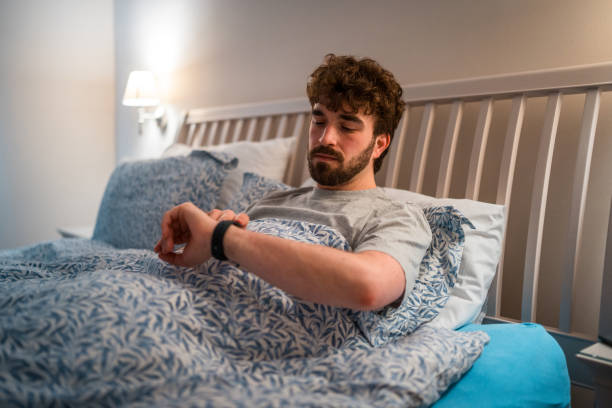 istock Caucasian Male with Sleep Disorder Checking Time at Night 2162330200