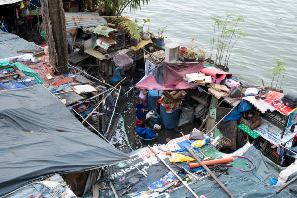 Manila, Philippines- 13 Oct 2023: Slums in Manila located along Pasig River. Residents of slum areas are commonly referred to as squatters