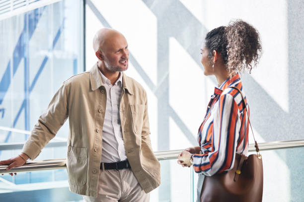 istock Internship, manager and meeting for people in training, collaboration or workshop in office for learning. Discussion, smile and talking in hallway for team, mentor or partnership in business law firm 2162337376