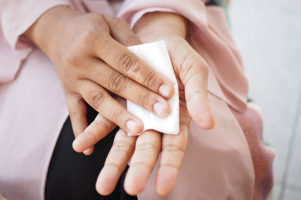 istock women disinfecting his hands with a wet wipe. 2162341367