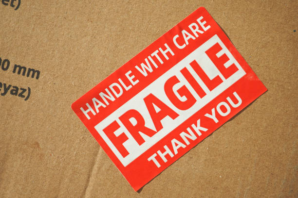 istock A cardboard box marked with a caution label for fragile goods handling during shipping 2162341401