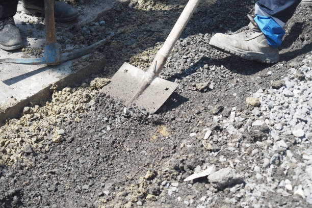 istock workers take stones with shovel to put into pit on road 2162341439