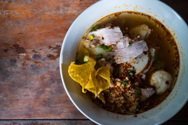 istock Thai noodles with pork served with crispy wontons. 2162344052