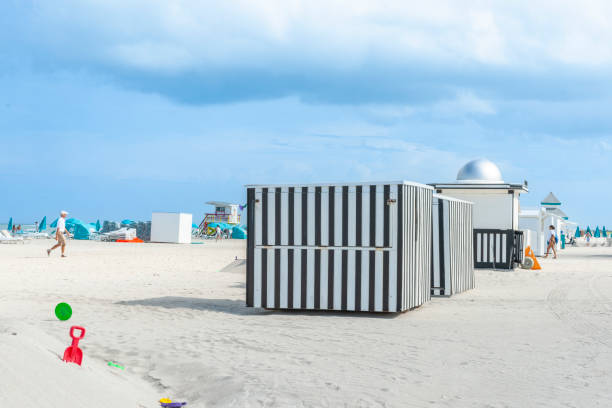 Miami Florida America - June 28 2012; Black and white vertical striped kiosks stand out  on the beach.