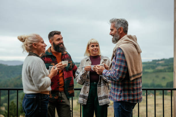 istock Multigenerational friends socialize on mountain cabin deck 2162347586
