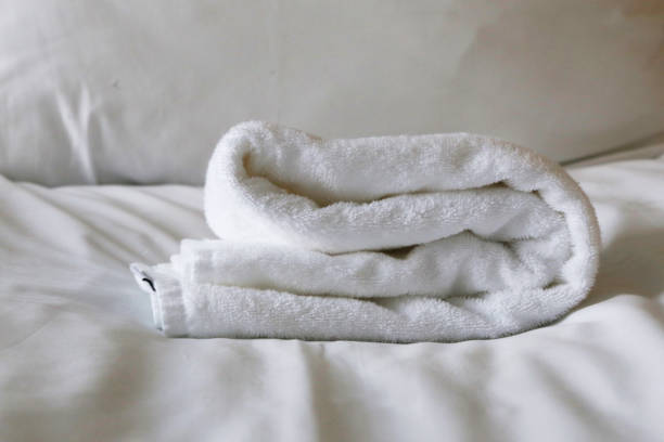 istock White folded terry towels on white bed. 2162351730