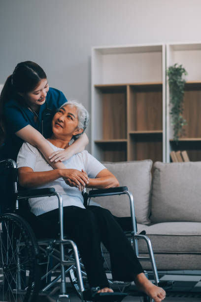 istock Asian physiotherapist helping elderly woman patient stretching arm during exercise correct with dumbbell in hand during training hand with patient Back problems in garden. Nursing home hospital 2162357328