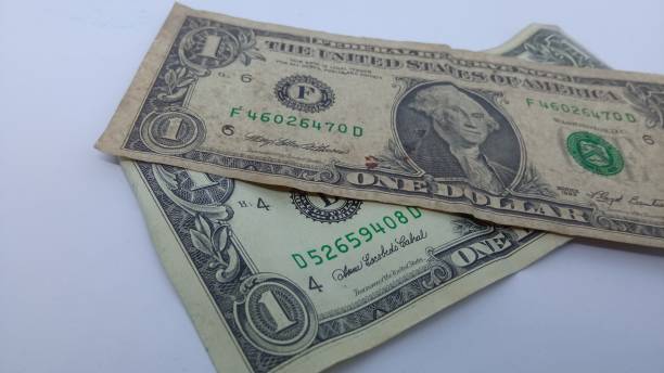 istock One battered 1 US Dollar bill and another one with better condition 2162358664
